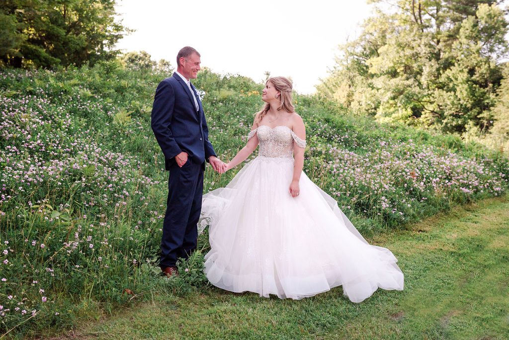 a wedding couple holds hands on the rough at the homestead resort.