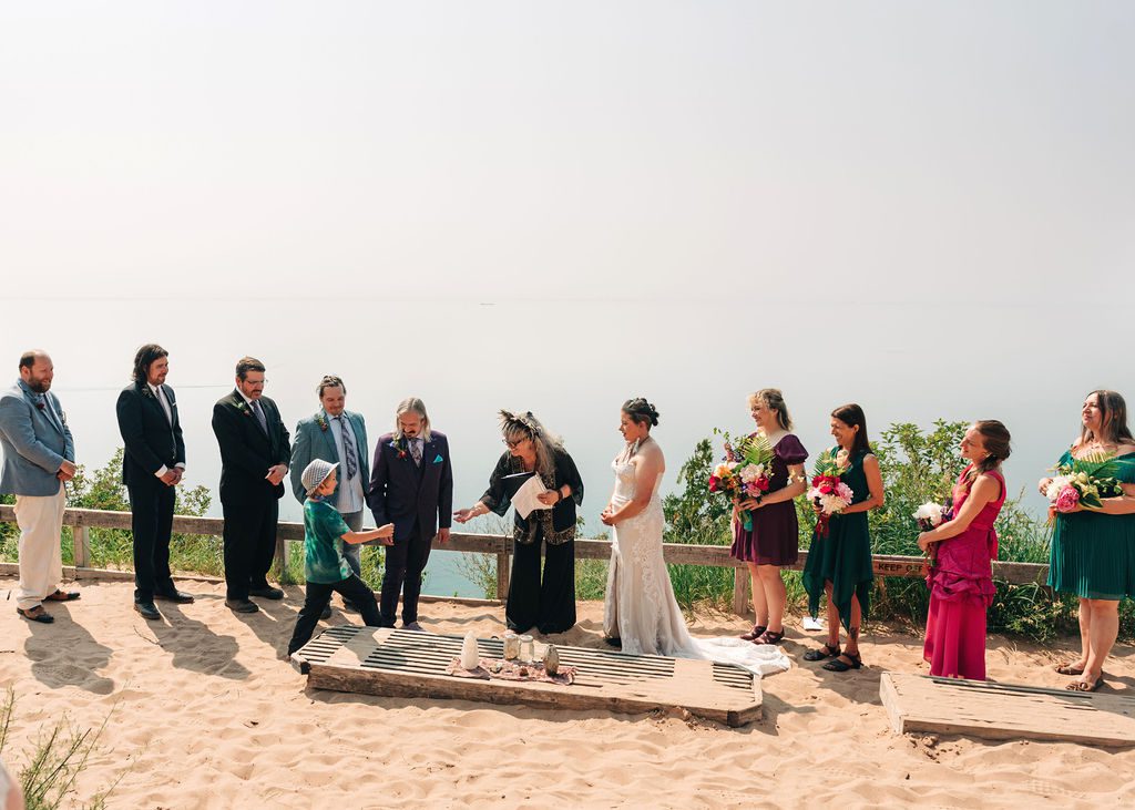 a small boy brings the rings to the couple, their nephew.