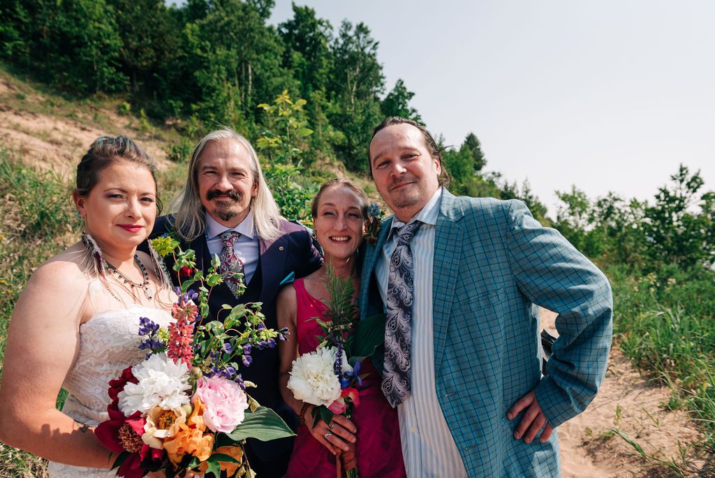 family with the wedding couple poses on Empire Bluff.