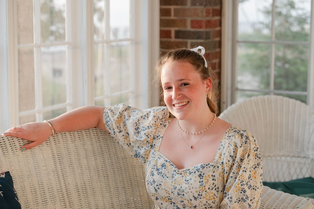 an indoor photograph of a graduating senior at Camp Arcadia.