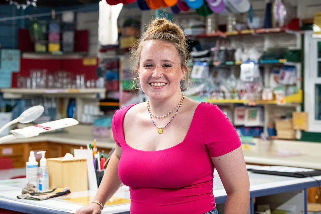 A senior portrait of a girl inside the crafting studio at Camp Arcadia.