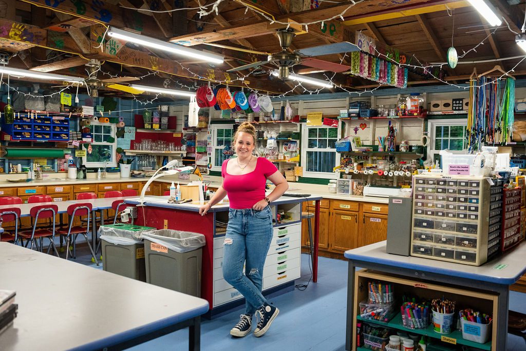 A senior portrait of a girl inside the crafting studio at Camp Arcadia.